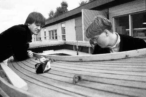 [Billede: To mænd, der er ved at bygge en båd]