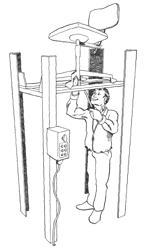 [Billede: Her ses en mand som står og reparere på en stol, som står på en lift.]