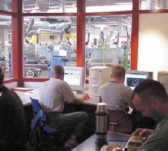 [Billede: Her ses nogle personer, som sidder og arbejder ved computere.]