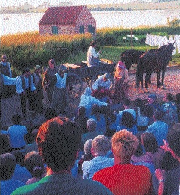 A horse-drawn cart arrives carrying bricks.